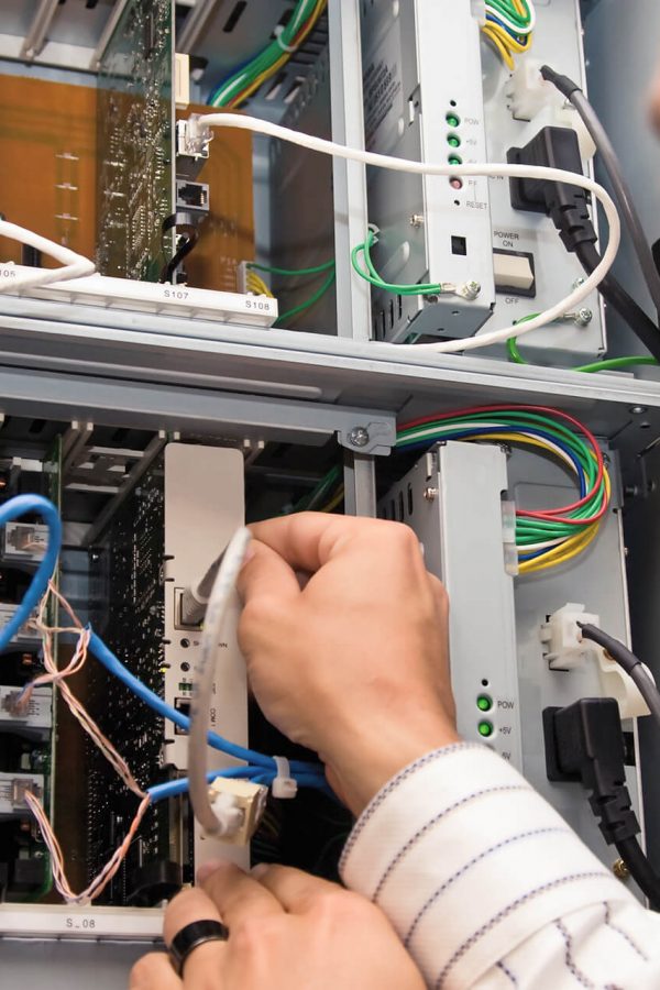 Data cabling calgary – it guy checking network cables Data cabling calgary - network cables